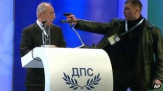 File image taken from video shows a man identified as Oktay Enimehmedov (R) as he points a weapon at Ahmed Dogan, 19 January 2013