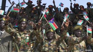 Members of South Sudan's military wave the national flag celebrating the anniversary of the country's first independence day on 9 July 2012 in Juba, South Sudan