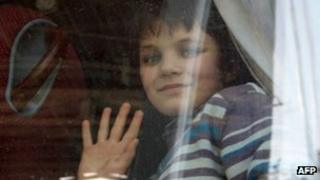 A Russian girl waves from a bus at the Masnaa border crossing between Syria and Lebanon, 22 January 2013