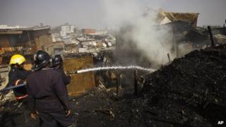Firefighters try to douse a fire in a shanty in Mumbai on Friday, Jan 25, 2013