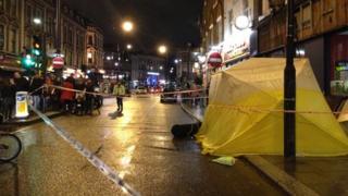 Police cordon around tent covering spot where man was hit by shop hoarding