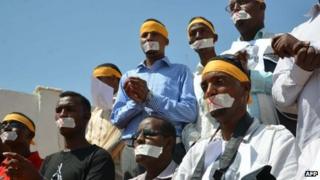 Somali journalists protest on Sunday 27 January 2013 in Mogadishu about the detention of their colleague in connection with a case of a woman who alleged she was raped by the security forces
