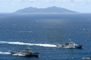 An aerial photo shows the Chinese marine surveillance ship Haijian No. 51 (L) cruising as a Japan Coast Guard ship Ishigaki sails near Uotsuri island, one of the disputed islands, called Senkaku in Japan and Diaoyu in China, in the East China Sea in this file photograph from 14 September 2012