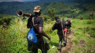 M23 rebels withdraw through the hills having left their position in the village of Karuba, eastern Democratic Republic of Congo, on 30 November 2012