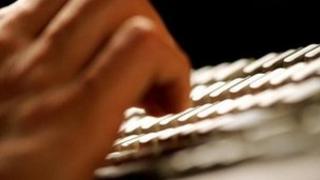 hand tapping keyboard