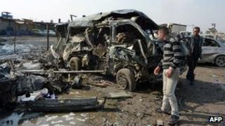 A destroyed car at the scene of Baghdad's bomb blasts. Photo: 8 February 2013