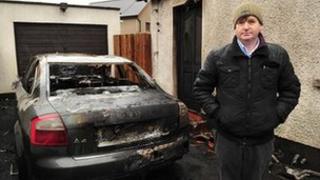 Willie Frazer standing at the scene of the arson attack