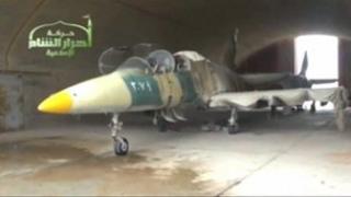 Still from Ugarit News video, purported to show fighter plane at al-Jarrah air base seized by rebels (12/02/13)