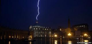 A flash of lighting is seen over St Peter's Basilica