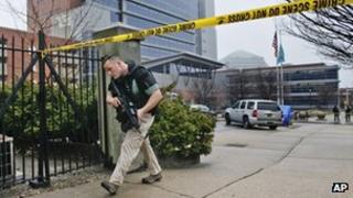 Law enforcement officials makes his way around the perimeter outside the New Castle County Courthouse in Wilmington, Delaware 11 February 2013