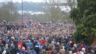 Crowds line the street