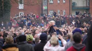 Crowds try to grab the ball