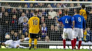 Rangers goalkeeper Neil Alexander saves a penalty from Annan's Scott Chaplain