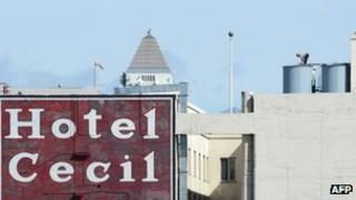 A worker stands on the water tanks of Hotel Cecil, Los Angeles, California 20 February 2013
