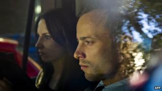 Olympic athlete Oscar Pistorius, right, and his sister Aimee are driven to a relative's home in Pretoria, South Africa, 22 February 2013