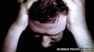 Man holding his head in his hands