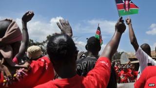 Youths participate in demonstration, waving Kenyan flags in the air