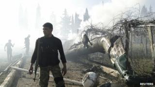 Rebels with wreckage of helicopter near Aleppo. 2 March 2013