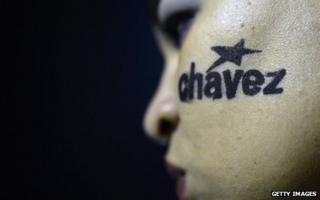 Mourner with Chavez written on her cheek