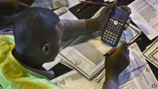 An electoral worker engages in a part of the tally verification process at the national tallying centre in Nairobi, Kenya, Wednesday 6 March 2013
