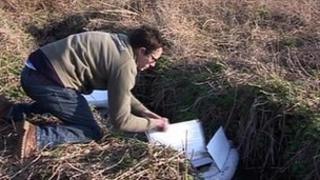 Working to soak up oil spill in a stream