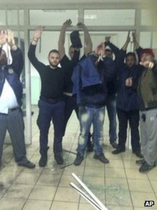 This photo reportedly shows a convict posing with a grenade and hostages inside Malandrino prison, central Greece, 16 March