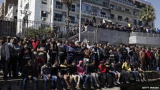 Residents of Port Said gather at a dock on the Suez Canal to demonstrate after the announcement of the final verdict in the case of the Port Said football massacre