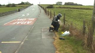 Flowers have been laid at the scene of the fatal collision near Amlwch