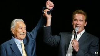 Arnold Schwarzenegger, right, raising the arm of Joe Weider, the creator of Mr Olympia Bodybuilding competition, during the 39th annual Mr Olympia event in Las Vegas, file pic from 2003