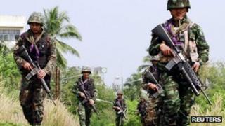 Thai security forces patrol the railway in the troubled southern province of Yala on 27 March 2013