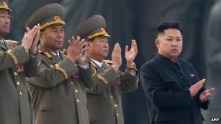 In a file picture taken on April 13, 2012, North Korean leader Kim Jong-Un (R) claps during the unveiling ceremony of two statues of former leaders Kim Il-Sung and Kim Jong-Il in Pyongyang.