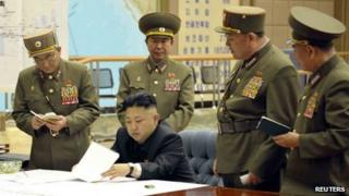 North Korean Kim Jong-un meets military officials (Unverified picture released by KCNA news agency 29 March)