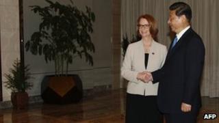China's President Xi Jinping shakes hands with Australia's Prime Minister Julia Gillard