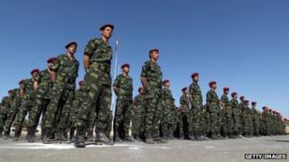 Soldiers of the Republican Guard stand to attention during a graduation ceremony