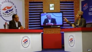 Rabi Lamichhane (right) speaks with the chairman of the Unified Communist Party of Nepal (Maoist) Pushpa Kamal Dahal (left) during the marathon broadcast