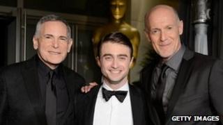 Craig Zadan and Neil Meron with Daniel Radcliffe (centre)