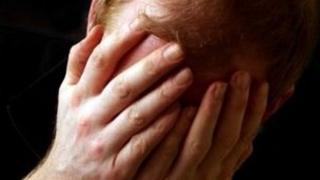 Man with hands on face