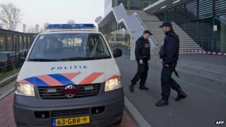 Dutch police stand outside the Da Vinci College in Leiden on 22 April 2013