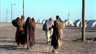A group of Afghan refugees arrive at an Iranian Red Crescent refugee camp near the border with Iran, October 2001