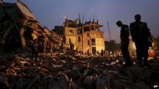 Bangladeshi soldiers stand in the rubble at the site of a building that collapsed Wednesday in Savar, near Dhaka, Bangladesh, 26 April 2013