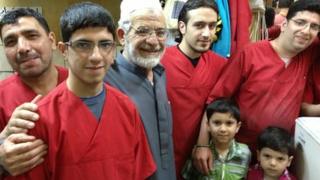 Haj Abed (grey shirt) with his staff