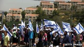 Israeli settlers march from the Ulpana outpost, in the West Bank settlement of Beit El, to the High Court of Justice in Jerusalem, on June 4, 2012.
