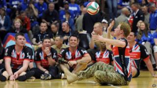 Prince Harry playing sitting volleyball.