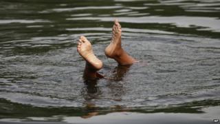 A boy cools off in Pakistan during the heatwave.