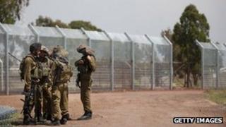 Israeli soldiers next to fence in occupied Golan Heights (file photo)