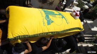 Men carry the coffin of a Hezbollah member killed in the Syrian town of Qusair, during his funeral in Sidon, southern Lebanon (22 May 2013)