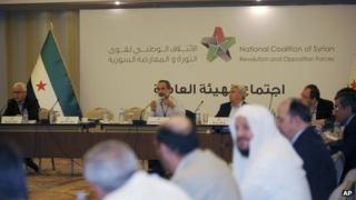 Head of the Syrian National Coalition for Opposition and Revolutionary Forces Moaz al-Khatib, rear-centre left, speaks during the group's meeting in Istanbul