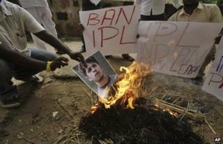 Activists of Kalinga Sena, a local political party, hold placards as they burn a poster of Indian cricketer Shanthakumaran Sreesanth at a protest against spot fixing during the Indian Premier League (IPL) in Bhubaneswar, India, Friday, May 17, 2013