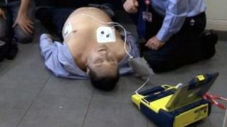 Employees during a training exercise on how to use an automatic electronic defibrillator (AED)