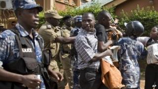 Media and members of Uganda's Human Rights Network for Journalists struggle with police as they protest outside the Daily Monitor newspaper head office, in Kampala, Uganda, 28 May 2013